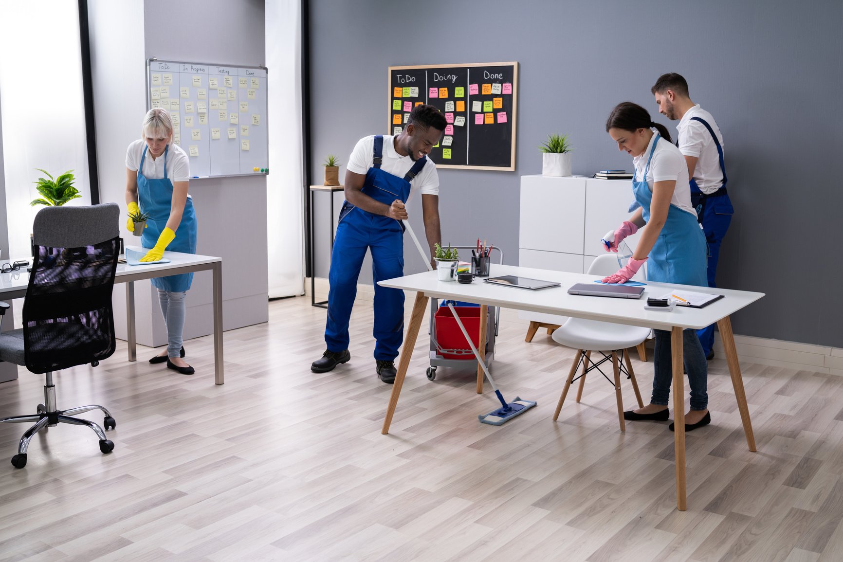 Happy Janitors Cleaning Office